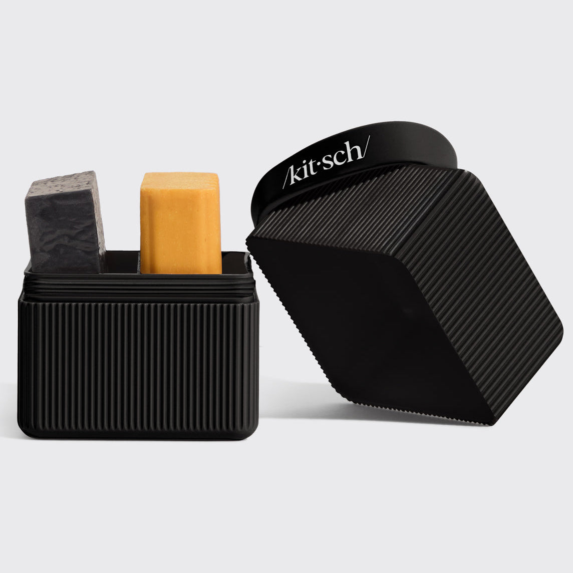 Black container with grooming products and 'kitsch' branding on a light gray background