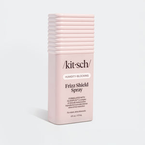 KITSCH Humidity Blocking Frizz Shield Spray — standalone bottle product shot on white background — full bottle view showing ridged cap and /kit·sch/ label — Humidity-Blocking | Frizz Shield Spray — Formulated with GLASSPLEX™ — For sleek, shiny blowouts — 6 fl. oz. / 177mL — adds intense shine & smooth glass-like finish