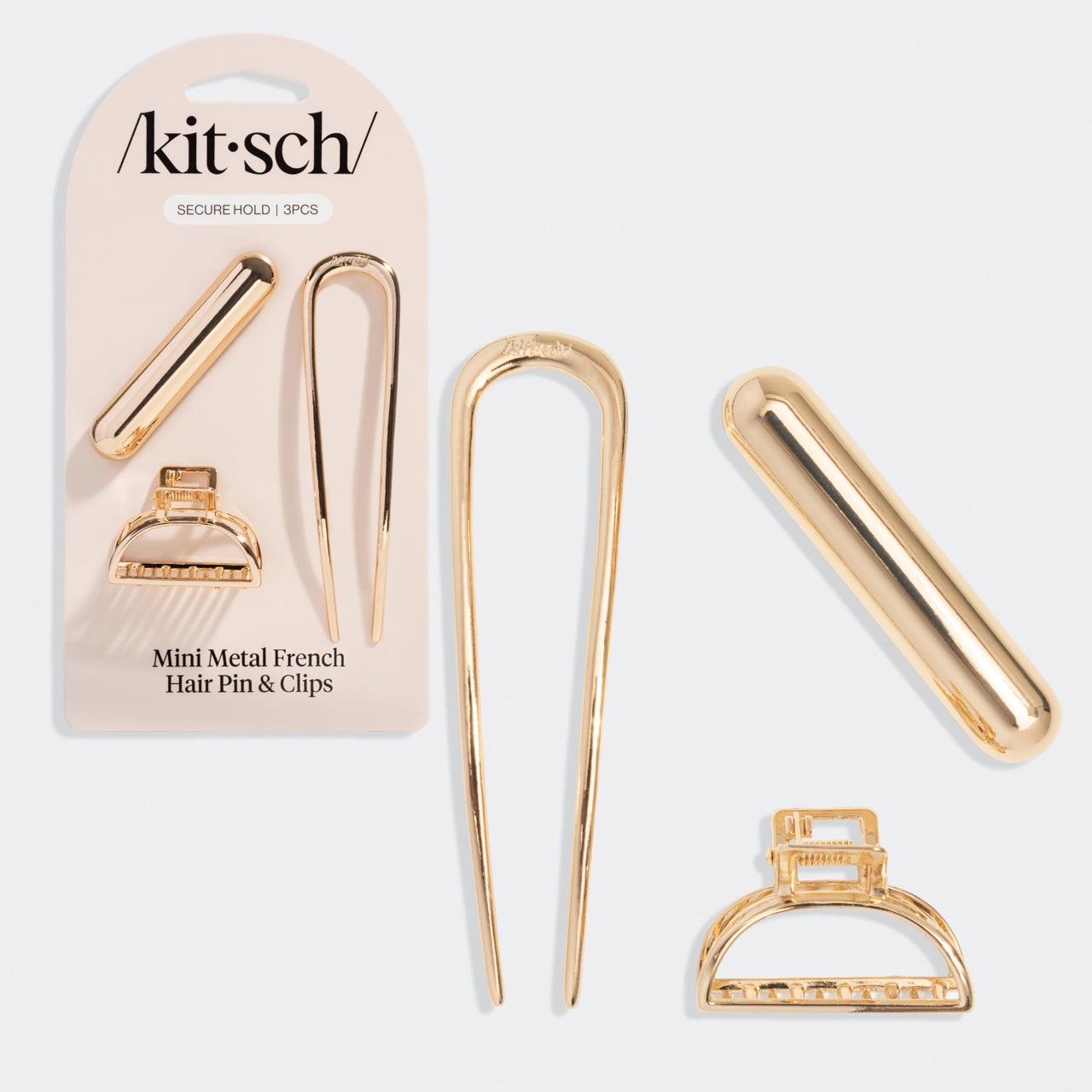 Gold mini metal French hair pin and clips with packaging on a grey background