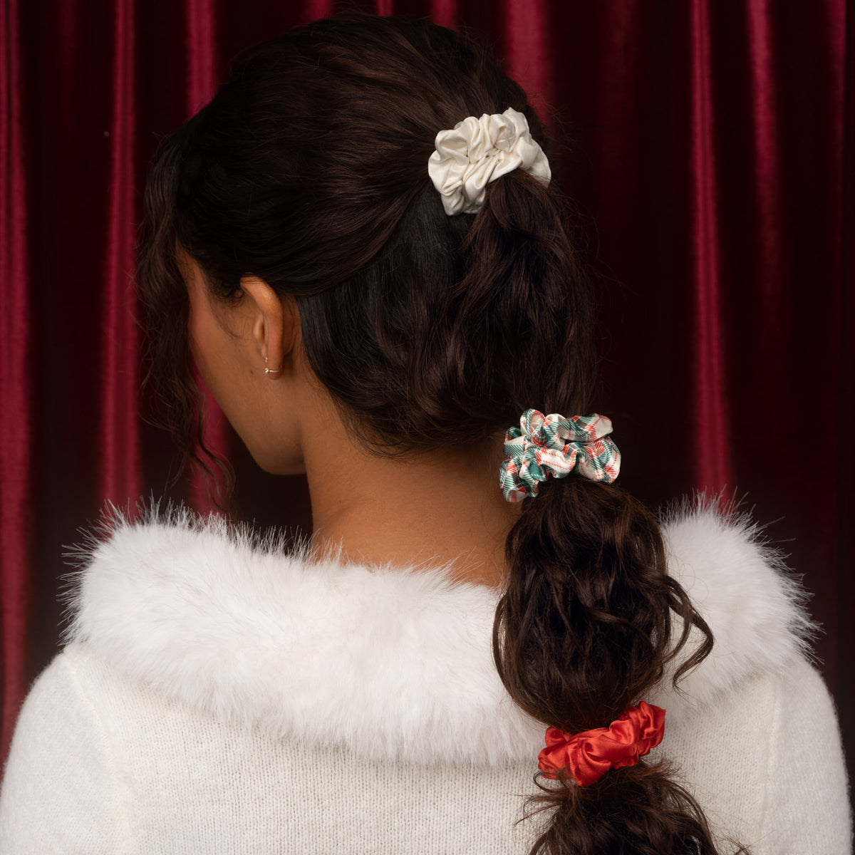 KITSCH Holiday Ruched Satin Scrunchies 7pc Set — back view of a model with scrunchies spaced down a low ponytail — Designed for all-day use or overnight wear — festive bubble ponytails