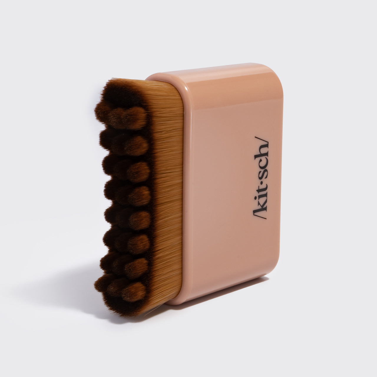Close-up of the terracotta Kitsch Lymphatic Contour Face Brush showing its soft hypoallergenic bristles