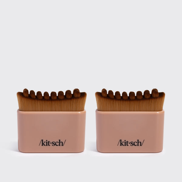 Two terracotta KITSCH Lymphatic Contour Face Brushes, front-facing packaging shot