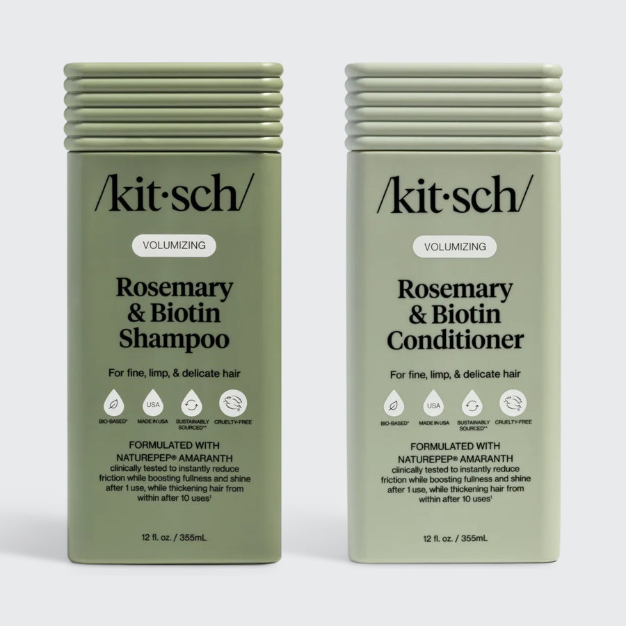 Two sage-green rectangular bottles of Kitsch Volumizing Rosemary & Biotin Shampoo and Conditioner for fine, limp, and delicate hair. The labels highlight the use of NaturePep Amaranth, noting it is clinically tested to reduce friction and boost fullness. The bottles feature icons for bio-based, made in USA, sustainably sourced, and cruelty-free.