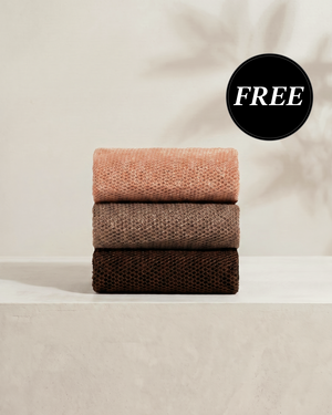 Kitsch Rosewood African Net Sponge set shown stacked in three terracotta tones, displaying the exfoliating mesh texture on a soft neutral background